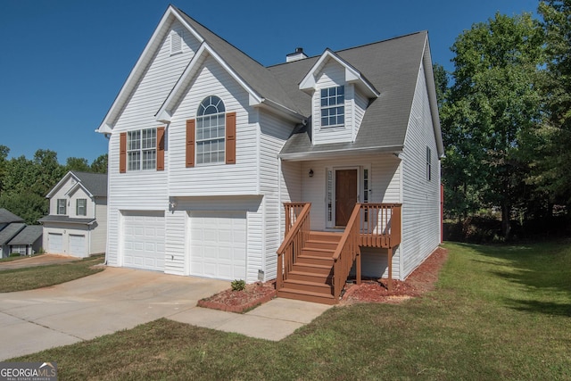 view of front facade with concrete driveway, a front yard, and a garage