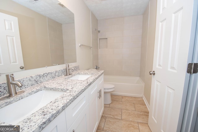 bathroom with a sink, double vanity, toilet, and shower / tub combination