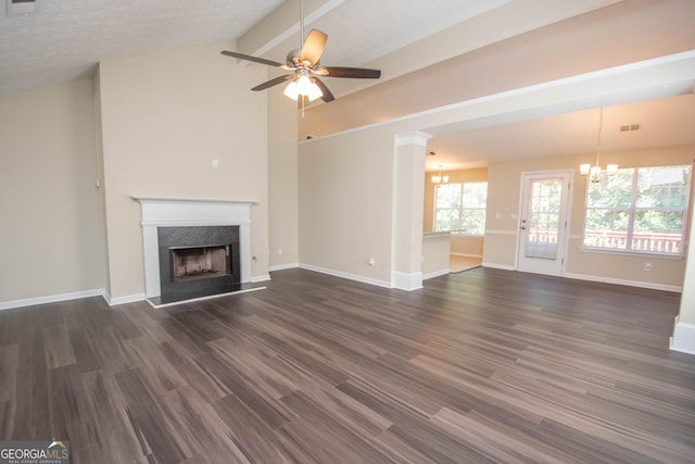 unfurnished living room featuring lofted ceiling, a premium fireplace, baseboards, ceiling fan with notable chandelier, and dark wood-type flooring