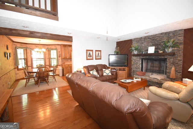 4056 Ryckeley Dr, Gainesville, GA 30504 - living room featuring a fireplace, light wood finished floors, and a chandelier