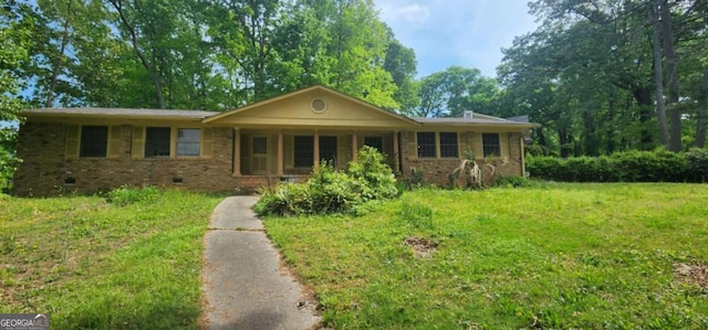 ranch-style home with brick siding, a front yard, and a porch