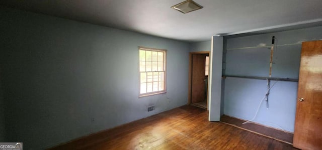 unfurnished bedroom featuring a closet and wood finished floors