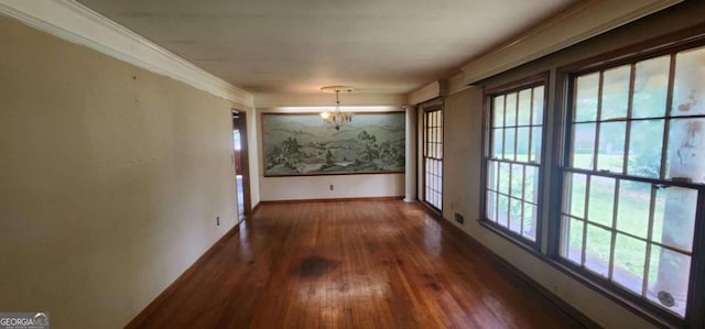 unfurnished dining area with crown molding, a chandelier, baseboards, and wood-type flooring