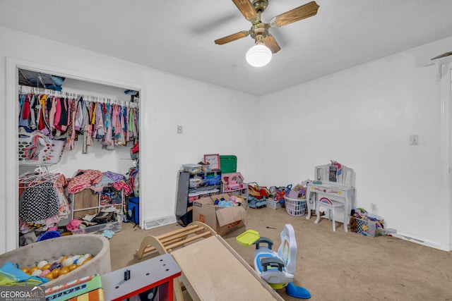 playroom with baseboards, a ceiling fan, and carpet floors