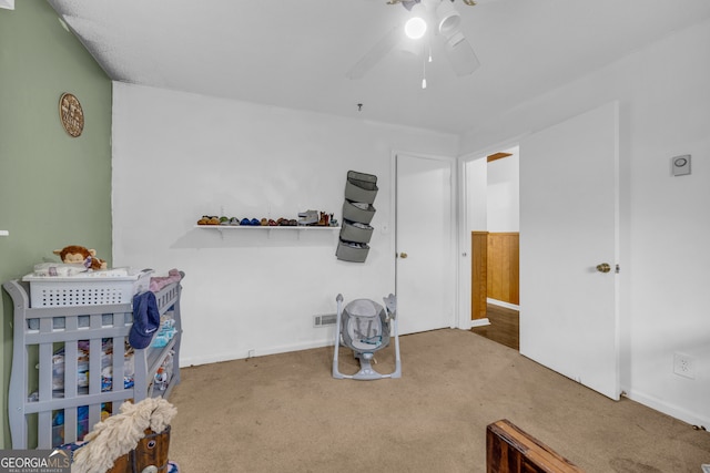 carpeted bedroom with visible vents, baseboards, and ceiling fan