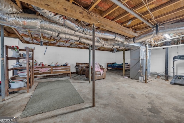 unfinished basement featuring heating unit