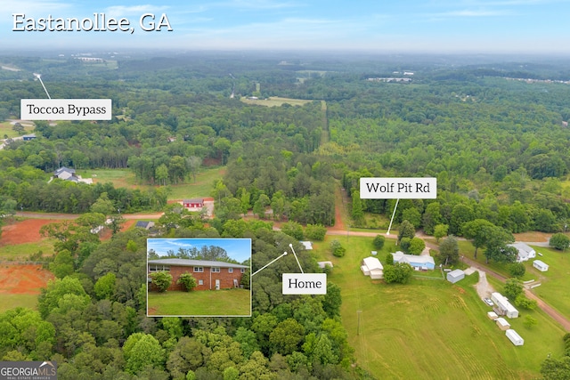 birds eye view of property with a wooded view
