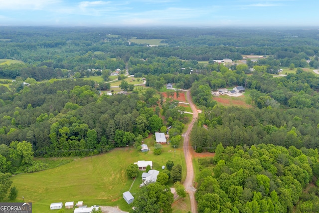 bird's eye view with a wooded view