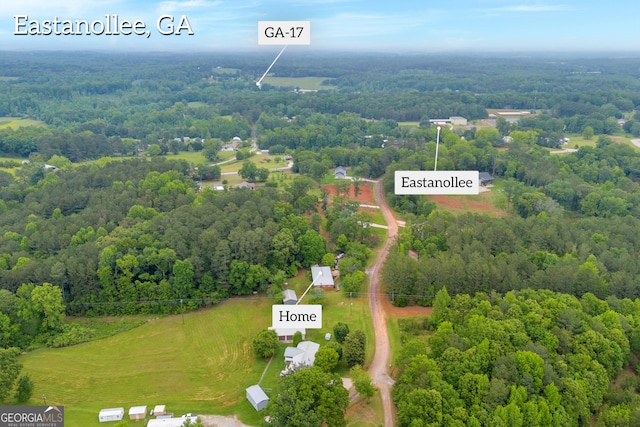birds eye view of property with a view of trees