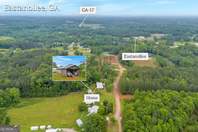 birds eye view of property with a wooded view