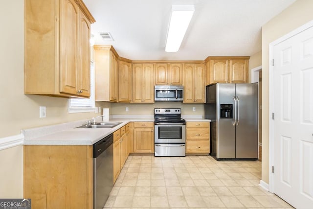 kitchen featuring a sink, visible vents, light brown cabinetry, light countertops, and appliances with stainless steel finishes