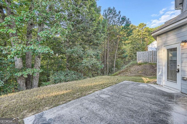 view of yard featuring a patio area and a forest view