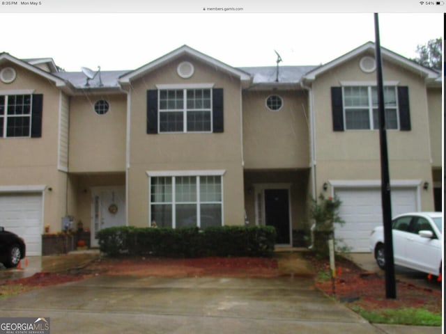 view of property with stucco siding and a garage