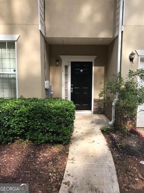 2320 Coach Way, Jonesboro, GA 30236 - doorway to property with stucco siding