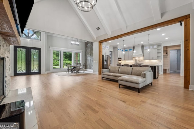 852 Tom Miller Rd, Bethlehem, GA 30620 - living area featuring high vaulted ceiling, beam ceiling, light wood-type flooring, visible vents, and a chandelier