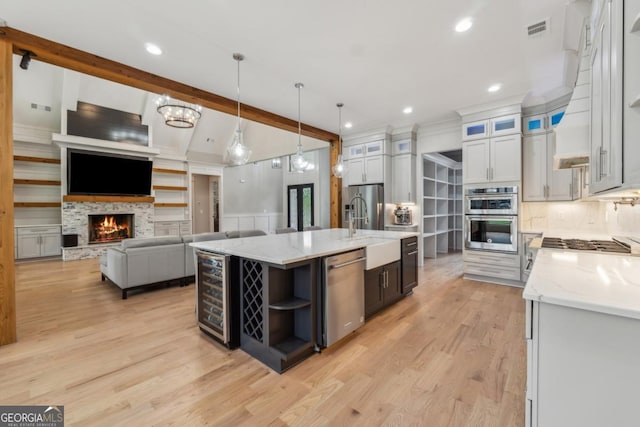 852 Tom Miller Rd, Bethlehem, GA 30620 - kitchen with light wood-style flooring, beverage cooler, visible vents, open shelves, and appliances with stainless steel finishes