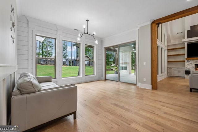 852 Tom Miller Rd, Bethlehem, GA 30620 - living room with a stone fireplace, a notable chandelier, light wood-style flooring, and visible vents
