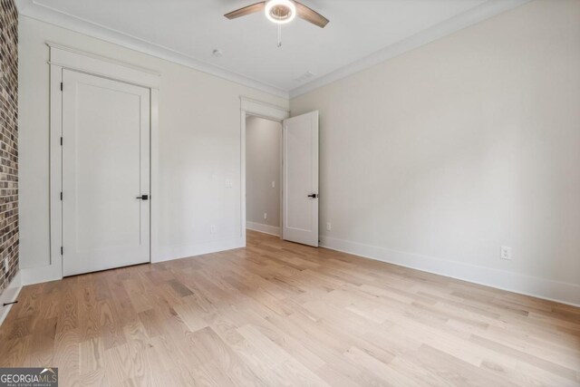 852 Tom Miller Rd, Bethlehem, GA 30620 - unfurnished bedroom featuring baseboards, light wood finished floors, crown molding, and a ceiling fan