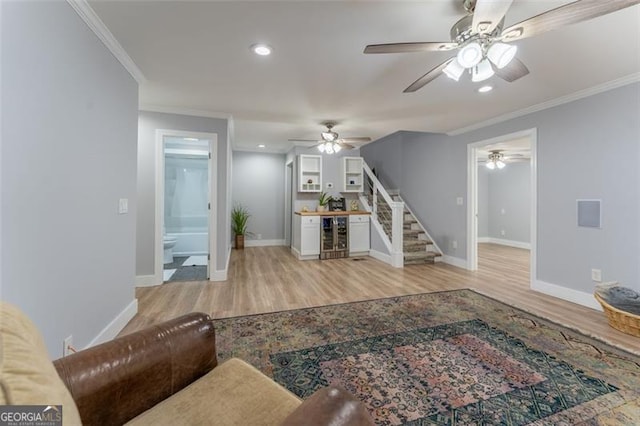 living room with a ceiling fan, stairs, wine cooler, and wood finished floors