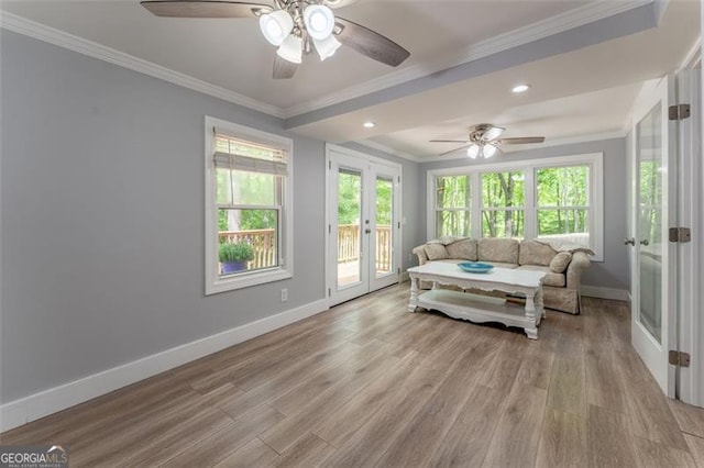 living area featuring ornamental molding, baseboards, a ceiling fan, and french doors