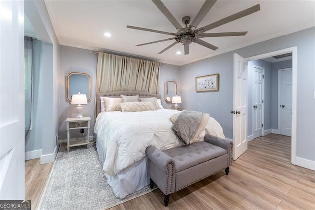 bedroom with crown molding, baseboards, light wood finished floors, and recessed lighting