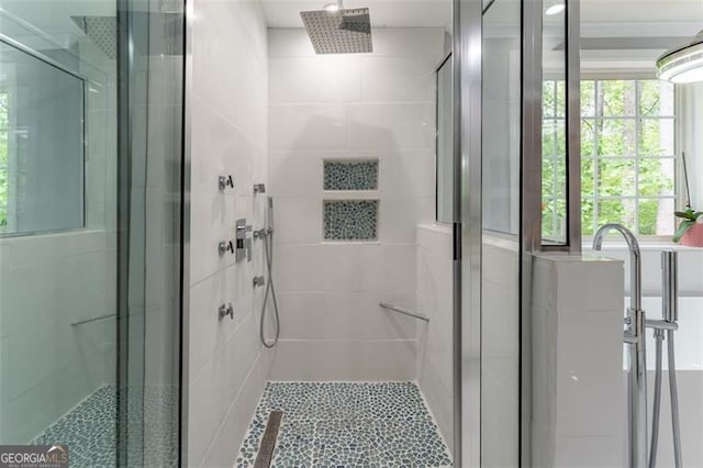 full bath featuring a shower stall, tile patterned floors, and plenty of natural light