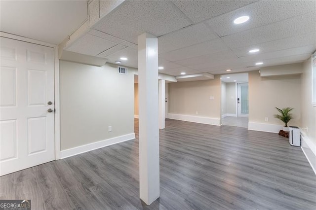 finished basement with recessed lighting, baseboards, visible vents, and wood finished floors