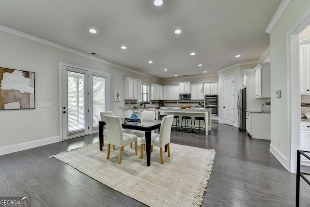 dining room with ornamental molding, dark wood-type flooring, recessed lighting, and baseboards