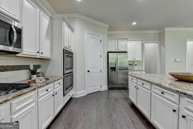 kitchen with stainless steel appliances, white cabinetry, decorative backsplash, recessed lighting, and dark wood finished floors