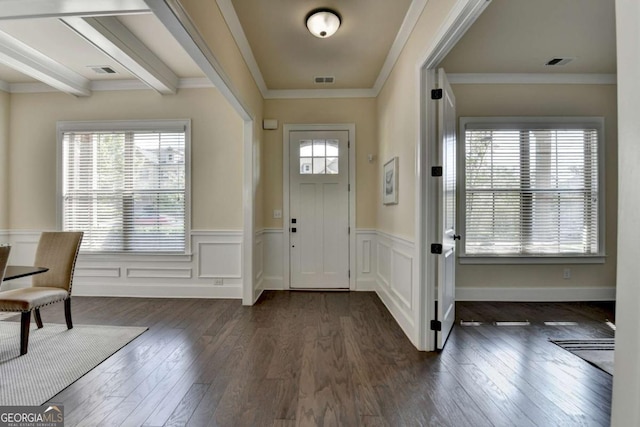 entryway with dark wood-type flooring, wainscoting, and ornamental molding
