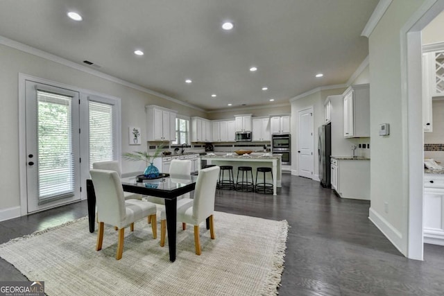dining room with crown molding, recessed lighting, dark wood finished floors, and baseboards