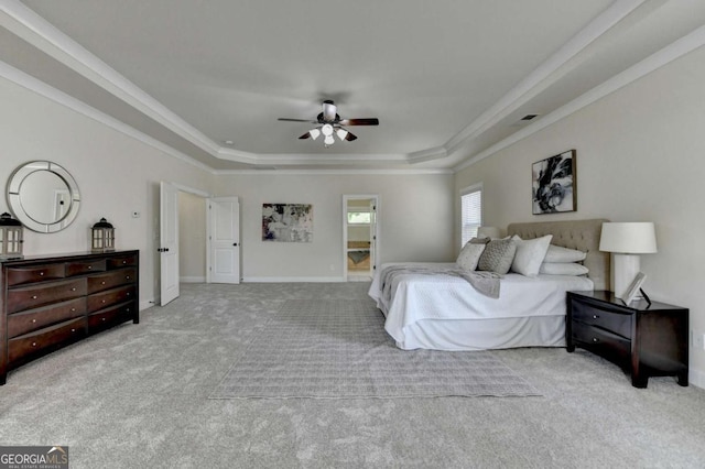bedroom featuring a raised ceiling, carpet flooring, ornamental molding, baseboards, and a ceiling fan