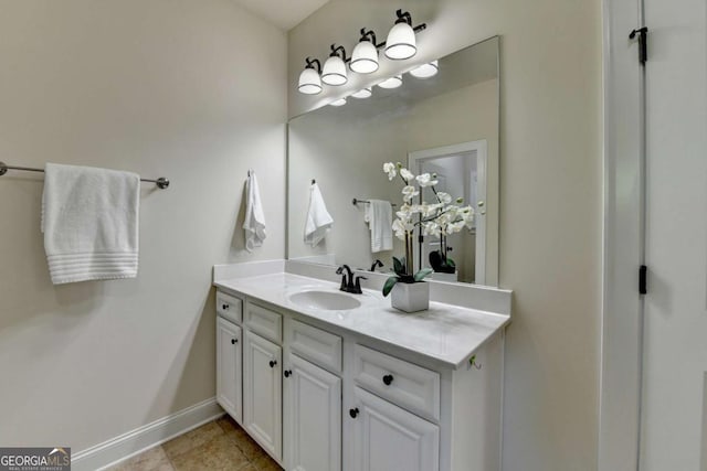 bathroom featuring vanity, baseboards, and tile patterned floors