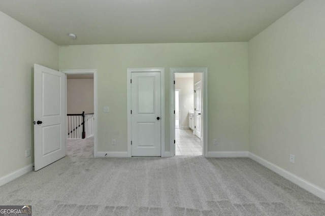 unfurnished bedroom featuring carpet flooring and baseboards