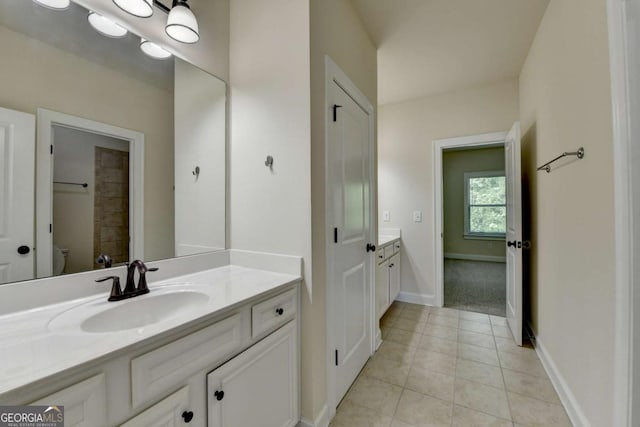 full bathroom featuring vanity, tile patterned floors, baseboards, and toilet