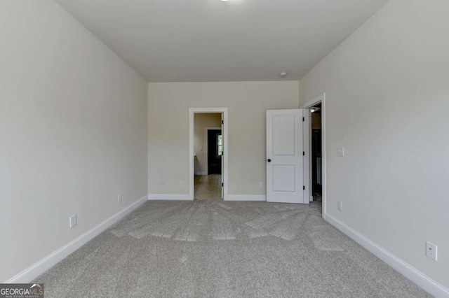 unfurnished bedroom with carpet and baseboards