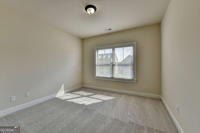 carpeted spare room with baseboards
