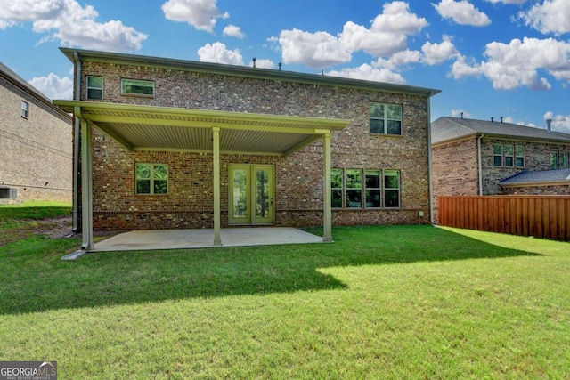 rear view of house with brick siding and a patio area