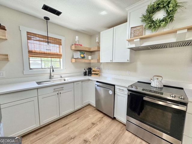 801 W Grossman Dr, Vidalia, GA 30474 - kitchen with appliances with stainless steel finishes, a sink, open shelves, light wood finished floors, and light countertops