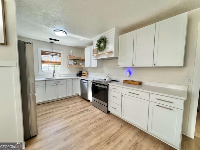 801 W Grossman Dr, Vidalia, GA 30474 - kitchen featuring appliances with stainless steel finishes, a sink, open shelves, a textured ceiling, and light countertops