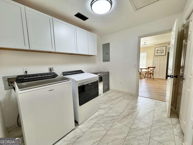 801 W Grossman Dr, Vidalia, GA 30474 - laundry area featuring cabinet space, independent washer and dryer, light marble finish floors, and electric panel