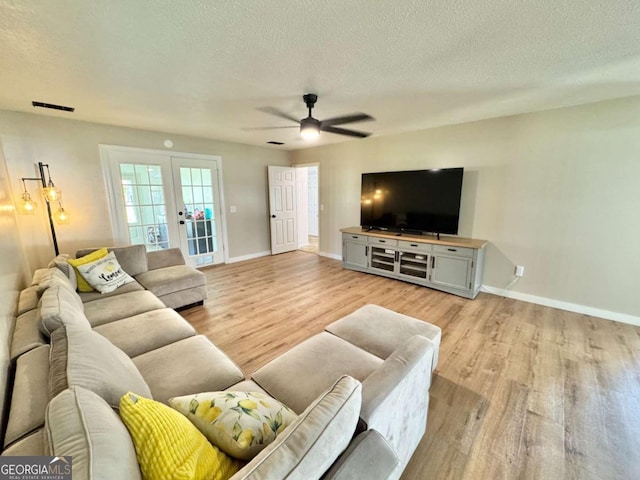 801 W Grossman Dr, Vidalia, GA 30474 - living area with french doors, light wood-type flooring, ceiling fan, baseboards, and a textured ceiling