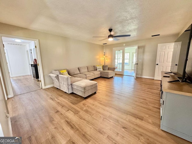 801 W Grossman Dr, Vidalia, GA 30474 - living room with a textured ceiling, ceiling fan, light wood-type flooring, and baseboards