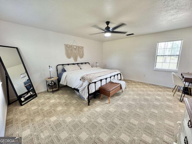 801 W Grossman Dr, Vidalia, GA 30474 - bedroom with light carpet, a textured ceiling, a ceiling fan, and baseboards