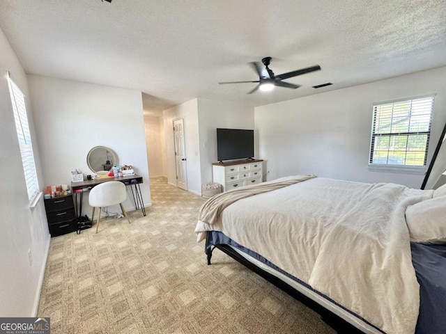801 W Grossman Dr, Vidalia, GA 30474 - bedroom featuring baseboards, a textured ceiling, ceiling fan, light carpet, and a desk