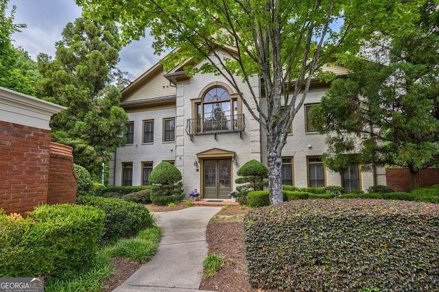 3127 Lenox Rd NE Unit 1, Atlanta, GA 30324 - view of front facade with french doors, brick siding, and a balcony