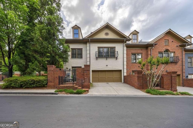 3127 Lenox Rd NE Unit 1, Atlanta, GA 30324 - view of property featuring concrete driveway, brick siding, and an attached garage