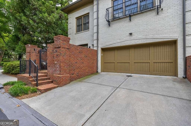 3127 Lenox Rd NE Unit 1, Atlanta, GA 30324 - view of property exterior with concrete driveway, brick siding, and a garage