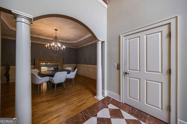 3127 Lenox Rd NE Unit 1, Atlanta, GA 30324 - interior space with a notable chandelier, ornamental molding, a wainscoted wall, arched walkways, and ornate columns