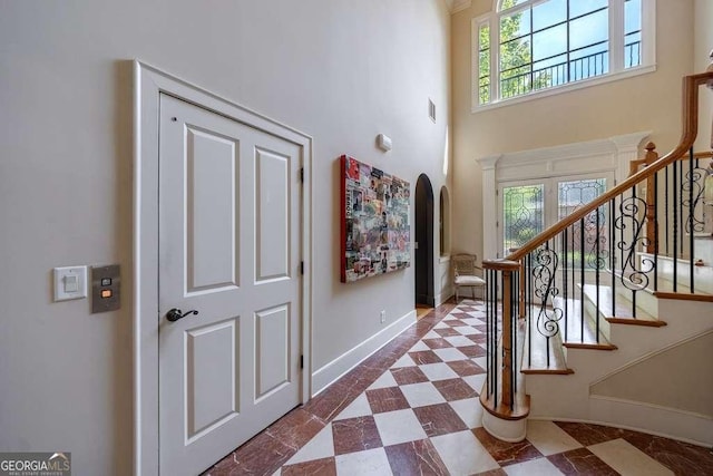 3127 Lenox Rd NE Unit 1, Atlanta, GA 30324 - entryway with stairs, visible vents, arched walkways, a high ceiling, and baseboards